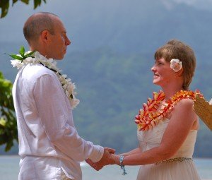 Closed ti leaf lei with white orchid wrap around and rainbow plumeria lei